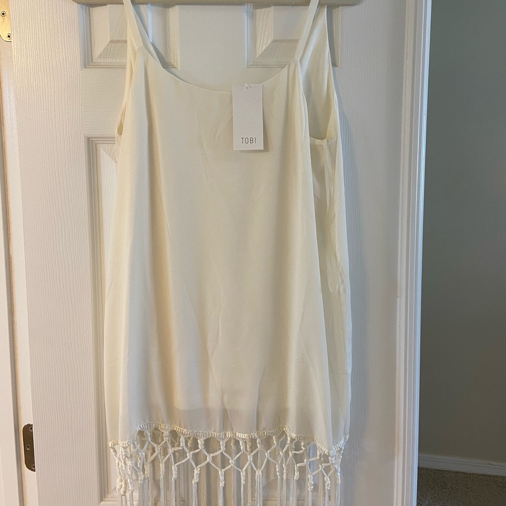 White mini dress with fringe along the bottom